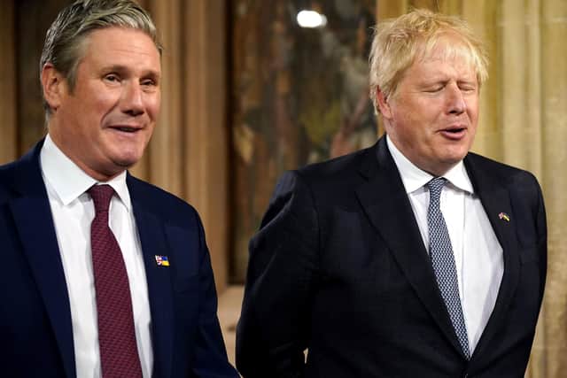 Prime Minister Boris Johnson (right) and the leader of the Labour Party Sir Keir Starmer in the Central Lobby at the Palace of Westminster during the State Opening of Parliament in the House of Lords, London. Picture: Yui Mok/PA Wire