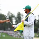 Bryson DeChambeau hands his club to his caddie on the first green during the first round of the 2024 Masters Tournament at Augusta National Golf Club. Picture: Maddie Meyer/Getty Images.