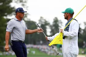 Bryson DeChambeau hands his club to his caddie on the first green during the first round of the 2024 Masters Tournament at Augusta National Golf Club. Picture: Maddie Meyer/Getty Images.