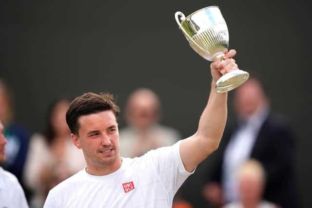 Great Britain's Gordon Reid celebrates with the trophy after victory against Japan's Takuya Miki and Tokito Oda (not pictured) in the Gentlemen's Wheelchair Doubles Final with team-mate Alfie Hewett.