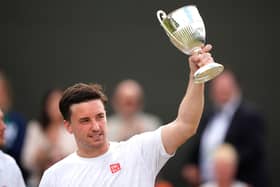 Great Britain's Gordon Reid celebrates with the trophy after victory against Japan's Takuya Miki and Tokito Oda (not pictured) in the Gentlemen's Wheelchair Doubles Final with team-mate Alfie Hewett.