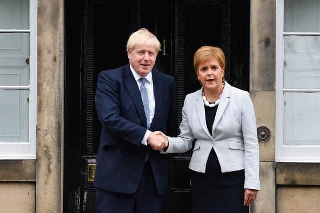 Scotland's First Minister Nicola Sturgeon welcomes Prime Minister Boris Johnson outside Bute House on July 29, 2019.