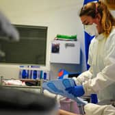 A nurse wearing an FFP3 face mask works on a patient in a critical care unit. Picture: PA Media