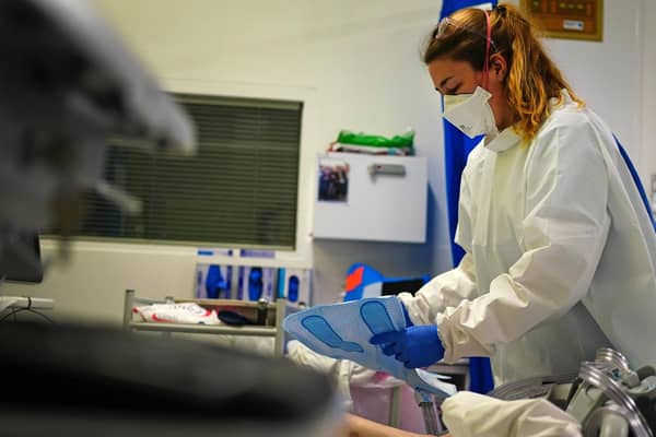 A nurse wearing an FFP3 face mask works on a patient in a critical care unit. Picture: PA Media