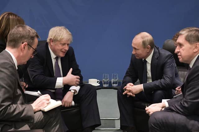 Boris Johnson and Vladimir Putin meet on the sidelines of a peace summit in Berlin in January 2020 (Picture: Alexey Nikolsky/Sputnik/AFP via Getty Images)