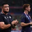 Scotland's Luke Crosbie, left, Zander Fagerson, centre, and Ben Healy react after the 36-14 defeat by Ireland in Pool B of the Rugby World Cup at the Stade de France.  (Photo by ANNE-CHRISTINE POUJOULAT/AFP via Getty Images)