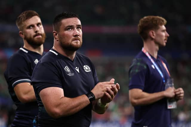 Scotland's Luke Crosbie, left, Zander Fagerson, centre, and Ben Healy react after the 36-14 defeat by Ireland in Pool B of the Rugby World Cup at the Stade de France.  (Photo by ANNE-CHRISTINE POUJOULAT/AFP via Getty Images)