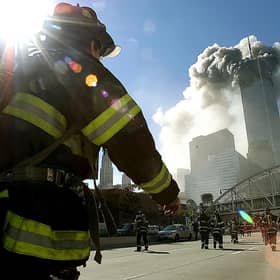 Firefighters walk towards one of the towers at the World Trade Center on September 11, 2001 (Getty Images)