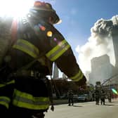 Firefighters walk towards one of the towers at the World Trade Center on September 11, 2001 (Getty Images)