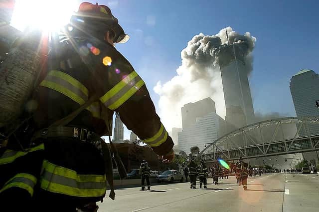 Firefighters walk towards one of the towers at the World Trade Center on September 11, 2001 (Getty Images)