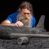 Artist Jamie Wardley working on one of his black sand sculptures commissioned by train operator LNER. Picture: Charlotte Graham