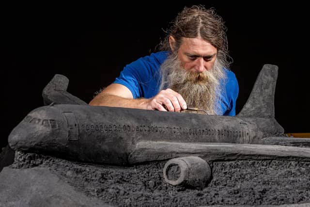 Artist Jamie Wardley working on one of his black sand sculptures commissioned by train operator LNER. Picture: Charlotte Graham