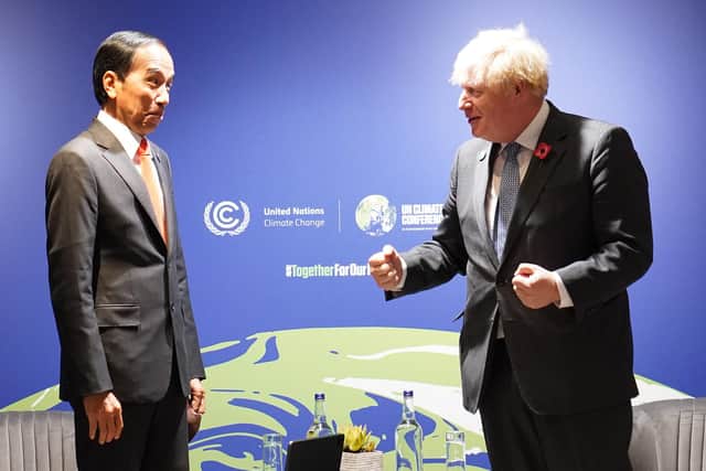 Prime Minister Boris Johnson greets Indonesian president Joko Widodo ahead of their bilateral meeting during the COP26 summit on Monday. Picture: Stefan Rousseau/Pool/Getty