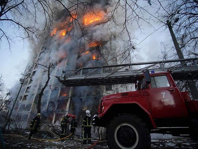 Pictured eleased by the State Emergency Service of Ukraine shows crews working to extinguish a fire in a housing block hit by shelling in the Sviatoshynsky district in western Kyiv. - Strikes on residential areas in Kyiv killed at least two people early on March 15, emergency services said, as Russian troops intensified their attacks on the Ukrainian capital. (Photo by State Emergency Service of Ukraine / AFP)