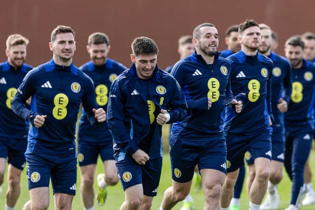 John McGinn leads the squad in warming up during a Scotland training session at Lesser Hampden on Tuesday. (Photo by Craig Foy / SNS Group)