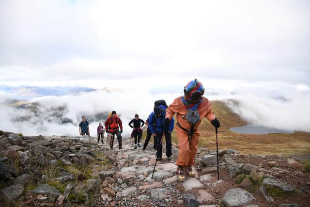 Veteran fundraiser Lloyd Scott, climbing Ben Nevis in a deep sea diving suit.
