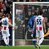 GLASGOW, SCOTLAND - MARCH 10: Rangers' goalkeeper Allan McGregor saves a penalty Red Star's Aleksandar Katai during a UEFA Europa League match between Rangers and Red Star Belgrade at Ibrox Stadium, on March 10, 2022, in Glasgow, Scotland. (Photo by Alan Harvey / SNS Group)