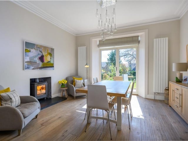 Open plan to the kitchen, the dining room has a wood burning stove and French windows to the garden.