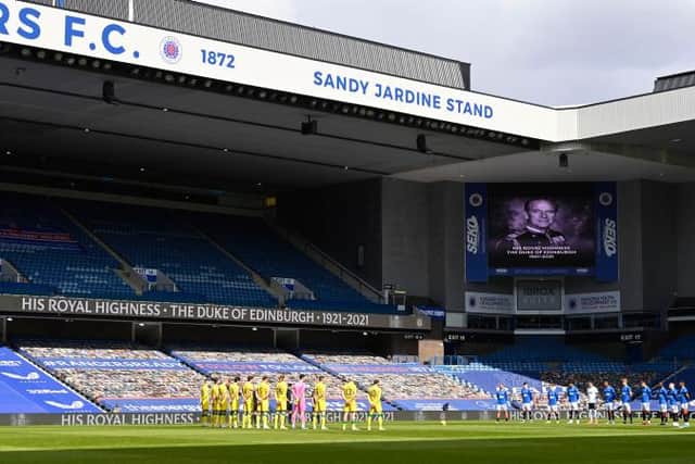 The players observe a minute's silence in memory of Prince Philip during a Scottish Premiership match between Rangers and Hibernian at Ibrox Stadium, on April 11, 2021, in Glasgow, Scotland. (Photo by Rob Casey / SNS Group)
