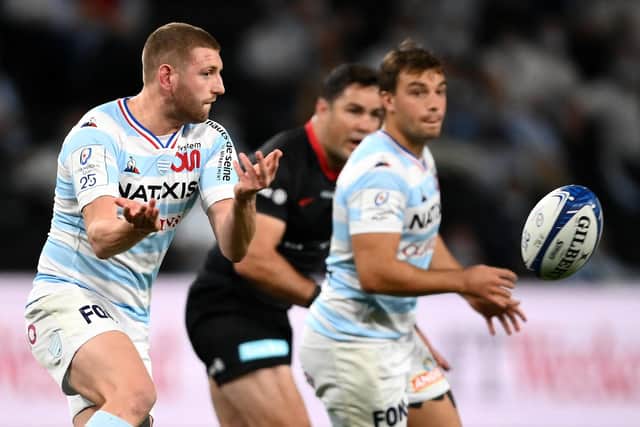 Finn Russell throws a disguised pass for Racing 92 against Saracens.