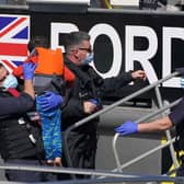 Border Force officers help a young child brought in to Dover, Kent, with a group of people thought to be migrants following a small boat incident in the Channel, September 8, 2021. Picture: Press Association