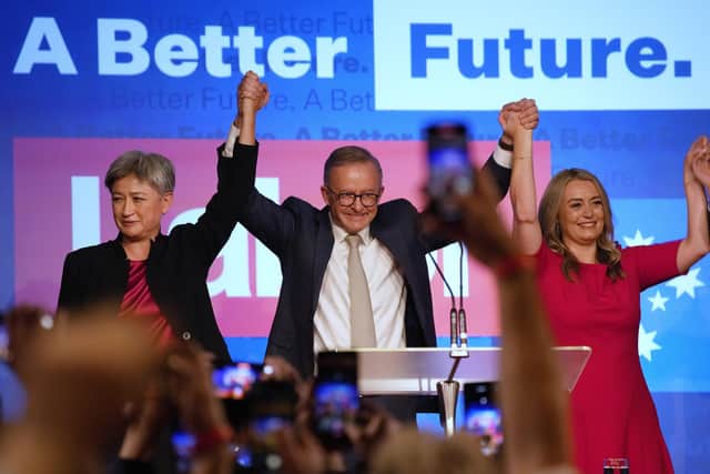 Labor Party leader Anthony Albanese, center back, celebrates with his partner partner Jodie Haydon, right, and Labor senate leader partner Penny Wong at a Labor Party event in Sydney, Australia, Sunday, May 22, 2022, after Prime Minister Scott Morrison conceding defeat to Albanese in a federal election. (AP Photo/Rick Rycroft)