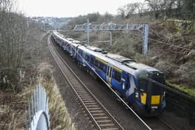 A ScotRail train on the main Edinburgh-Glasgow passes near the site of the proposed Winchburgh Station. The previous station closed in 1930. (Photo by Lisa Ferguson/The Scotsman)