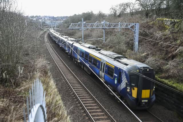 A ScotRail train on the main Edinburgh-Glasgow passes near the site of the proposed Winchburgh Station. The previous station closed in 1930. (Photo by Lisa Ferguson/The Scotsman)