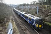 A ScotRail train on the main Edinburgh-Glasgow passes near the site of the proposed Winchburgh Station. The previous station closed in 1930. (Photo by Lisa Ferguson/The Scotsman)