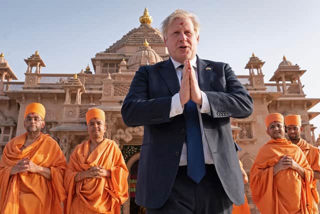 Boris Johnson was visiting India as MPs voted for him to be reported to the Privileges Committee