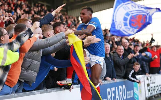 Alfredo Morelos leaps into the visiting support to celebrate his 100th goal for Rangers in their 2-1 win over St Mirren on Sunday. (Photo by Craig Williamson / SNS Group)