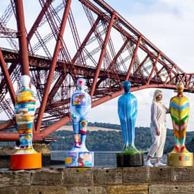 Isy Langhorne stands beside Gratitude sculptures erected as tribute to NHS key workers (Photo: Lisa Ferguson).