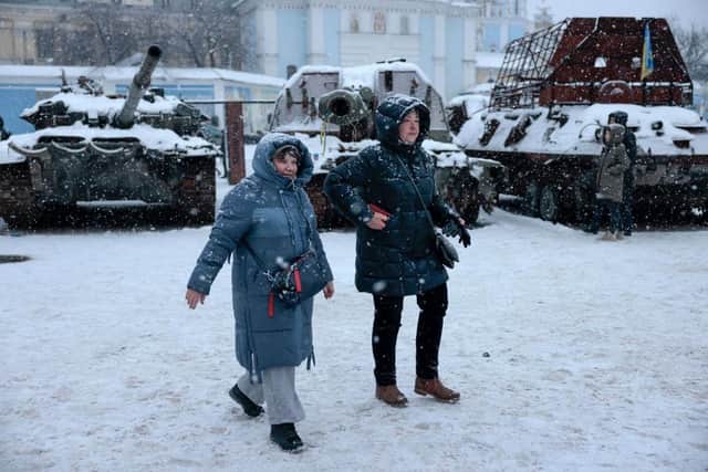 Members of the public are seen in the snow in Kyiv, Ukraine. Ukrainian officials expect a new wave of Russian bombing this week, with previous rounds targeting critical infrastructure and causing massive water and power cuts, including in the capital Kyiv.