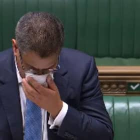Business Secretary Alok Sharma wipes his face during a speech in the House of Commons. Sharma has been tested for coronavirus after becoming visibly unwell in the debating chamber