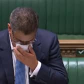 Business Secretary Alok Sharma wipes his face during a speech in the House of Commons. Sharma has been tested for coronavirus after becoming visibly unwell in the debating chamber