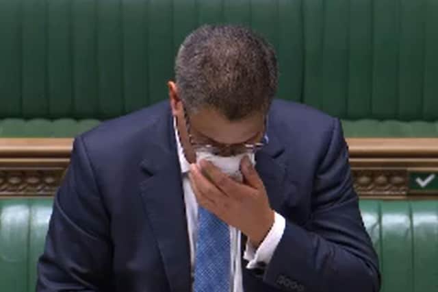 Business Secretary Alok Sharma wipes his face during a speech in the House of Commons. Sharma has been tested for coronavirus after becoming visibly unwell in the debating chamber