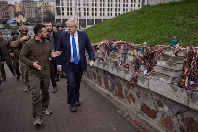 Boris Johnson and Ukrainian President Volodymyr Zelensky walking past portraits of Heavenly Hundred Heroes in central Kyiv