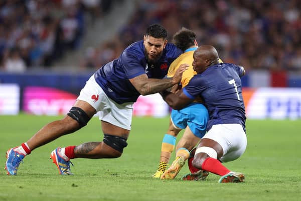 Santiago Arata of Uruguay is tackled by Romain Taofifenua and Sekou Macalou of France which resulted in a yellow card for Taofifenua for a dangerous tackle. (Photo by Warren Little/Getty Images)