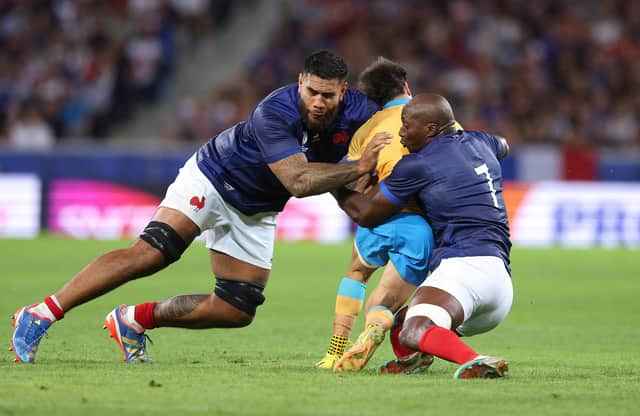 Santiago Arata of Uruguay is tackled by Romain Taofifenua and Sekou Macalou of France which resulted in a yellow card for Taofifenua for a dangerous tackle. (Photo by Warren Little/Getty Images)