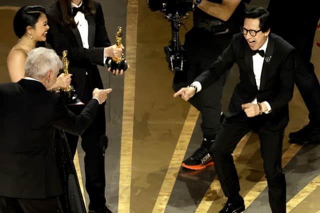 Ke Huy Quan accepts the award for Best Picture for "Everything Everywhere All at Once" from Harrison Ford onstage during the 95th Annual Academy Awards at Dolby Theatre on March 12, 2023 in Hollywood, California. (Photo by Kevin Winter/Getty Images)