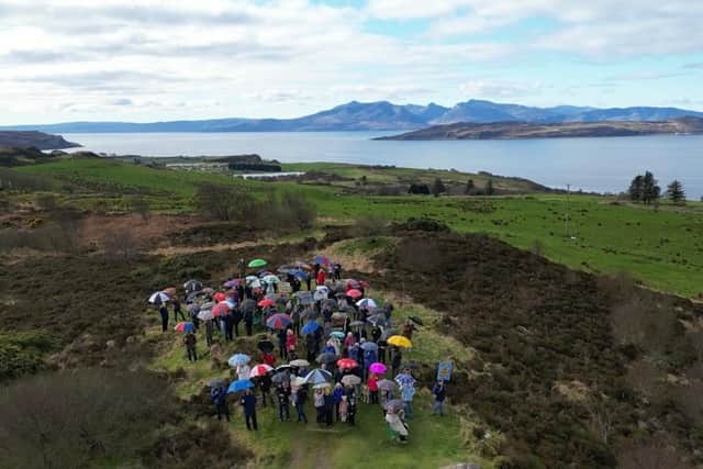 Protesters gathered with umbrellas raised to show their objection to the 12,000-panel solar farm and battery storage scheme on the island of Great Cumbrae in the Clyde