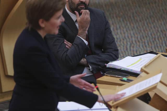 Health secretary Humza Yousaf looks on as First Minister Nicola Sturgeon speaks. Picture: Fraser Bremner