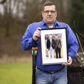 Alan Kennedy at the Erskine Home in Bishopton, Renfrewshire, holding a picture of himself in the Royal Scots army with his father. Picture: PA