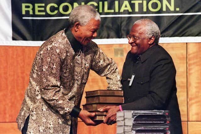 Nelson Mandela receives Truth and Reconciliation Commission's final report from Archbishop Desmond Tutu