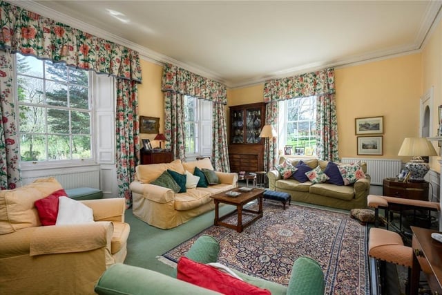 The beautifully proportioned drawing room overlooks the garden with southeast and northeast facing windows with working shutters and has an open fireplace and shelved alcove.