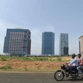 Men ride a motorbike at GIFT City, the emerging global financial and IT services hub in Gandhinagar, Gujarat, which offers several key incentives for global firms (Picture: Sam Panthaky/AFP via Getty Images)
