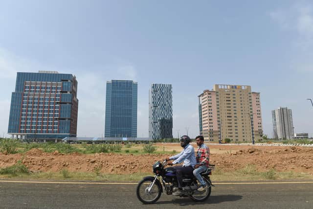 Men ride a motorbike at GIFT City, the emerging global financial and IT services hub in Gandhinagar, Gujarat, which offers several key incentives for global firms (Picture: Sam Panthaky/AFP via Getty Images)