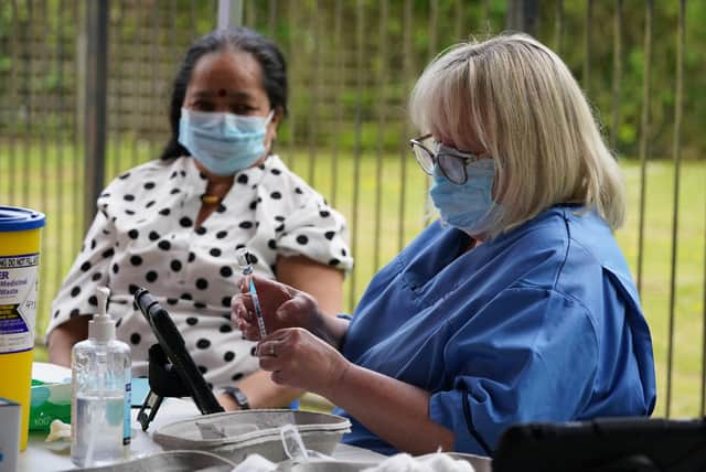 Nurse Lorraine Mooney gives a vaccination to a member of the public in the car park of Crieff Community Hospital (Picture: Andrew Milligan/PA)