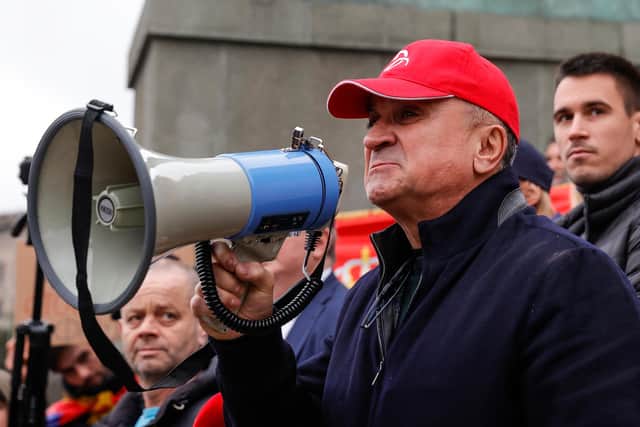 Srdan Dojkovic, father of Serbian tennis player Novak Djokovic, uses a megaphone to address a rally in front of Serbia's national assembly as the world no.1 tennis player fights deportation from Australia after his visa was cancelled (Photo by Srdjan Stevanovic/Getty Images)