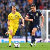 John McGinn is challenged by Oleksandr Zinchenko during the FIFA World Cup Qualifier at Hampden Park on June 01, 2022 in Glasgow, Scotland. (Photo by Mark Runnacles/Getty Images)